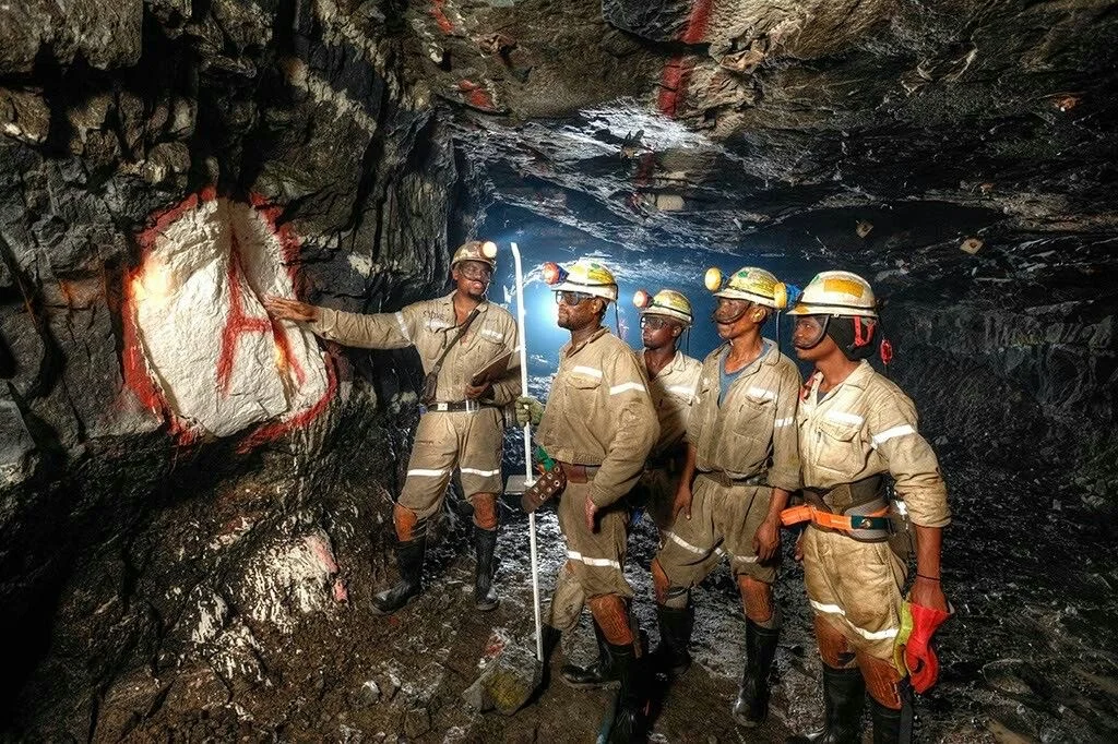 Underground crew inspecting a rock face